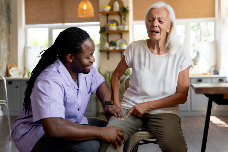 Volunteer ministering to elderly resident in a nursing home, providing spiritual encouragement and companionship through prayer and conversation